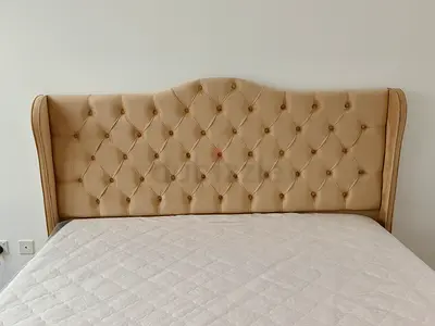 Beige tufted queen bed headboard with wingback design