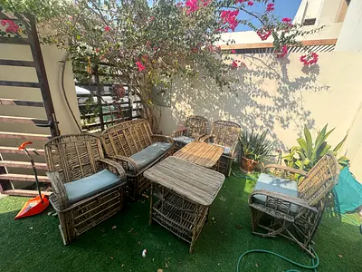 6-piece rattan outdoor patio seating set with cushions.