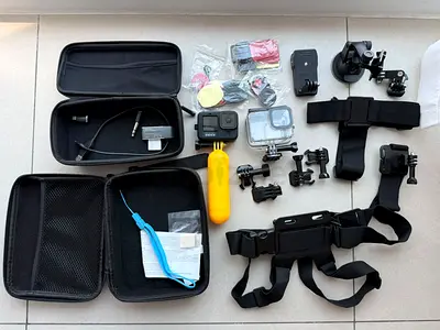 GoPro-style action camera with mounts, chest/head straps and accessories bundle