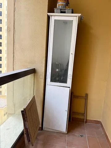 Tall white balcony/storage cabinet