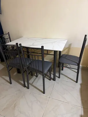 4-seater dining table set with marble-look top and grey chairs with Cushions
