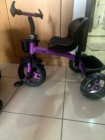 Used purple toddler tricycle with parent handle