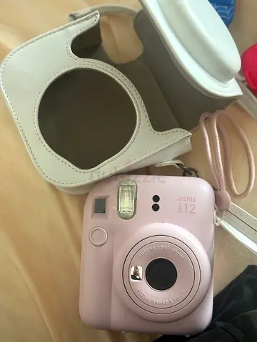 Pink Fujifilm Instax Mini 12 instant camera with case