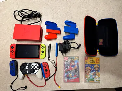 Nintendo Switch console bundle with controllers, case and 2 games (Mario Odyssey, Maker 2)