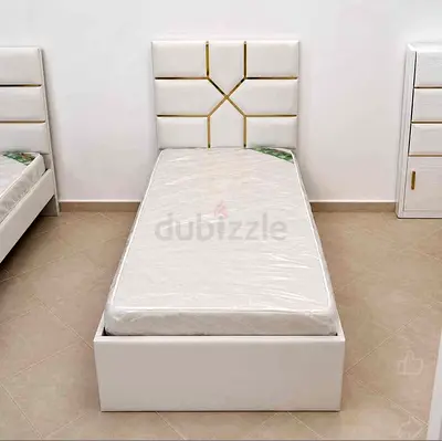 Single white upholstered bed with mattress and storage base