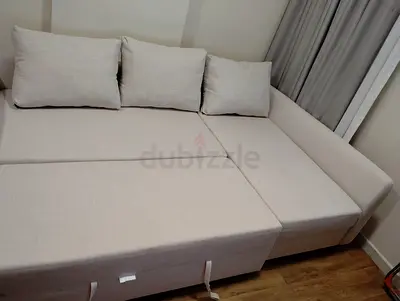 Light beige L-shaped sofa bed with storage - excellent condition