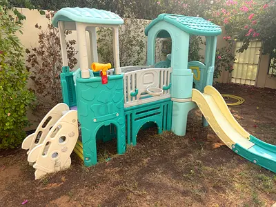 Outdoor playset with slide and climbing features - very good condition