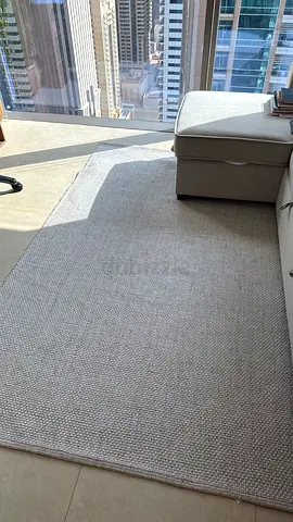 Light grey woven area rug - good condition