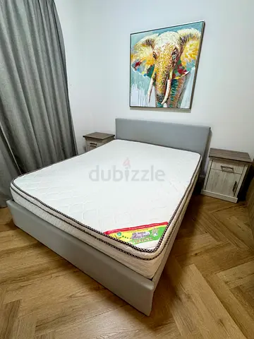 IKEA bed with mattress and nightstands
