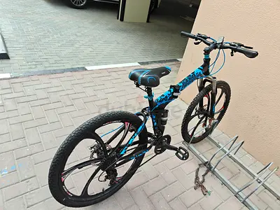 Blue and black kids/teen mountain bike - good condition. With right side / rear gear.