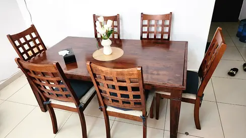 Solid Wood 6-Seater Dining Table with Cushioned Chairs.