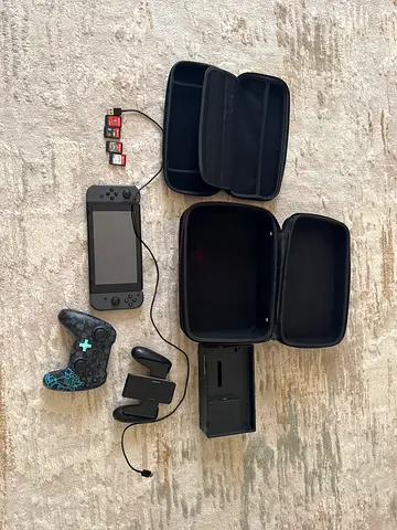 Nintendo Switch console with  controller, Joy-Con grip, dock , 2 carry cases and 4 games