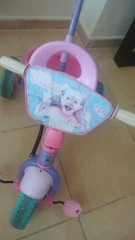Pink Disney-themed toddler tricycle with handle - good condition