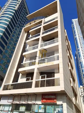 A mixed-use residential and commercial building for sale in Al Majaz 3, Sharjah. It is a corner property located on Al Khan Street near Al Qasba Canal