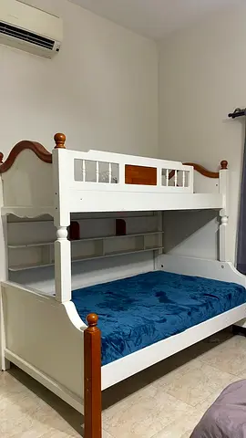 White wooden bunk bed with storage shelves — excellent condition