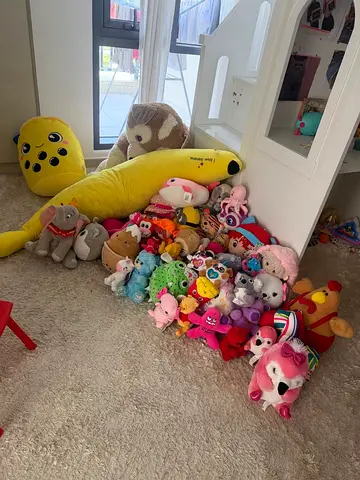 Large bundle of assorted soft plush toys — mix of small and oversized stuffed animals