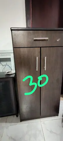 Compact dark wood storage cabinet with drawer and double doors - good condition