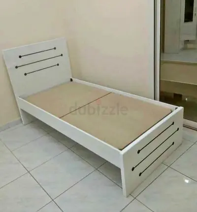 Single white wooden bed frame with headboard and footboard