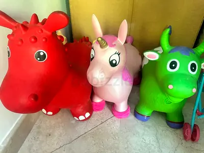Set of 3 Bouncy Ride-On Toys (Unicorn, Red Animal, Green Cow) - Good Condition