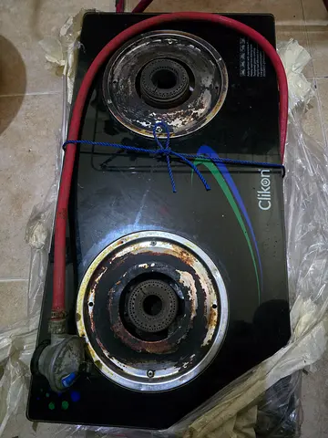 Used two-burner glass top gas stove with regulator and hose and cylinder