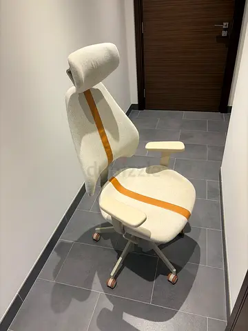 Ergonomic swivel office chair in cream with lumbar support and armrests