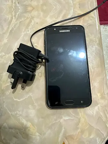 Samsung Galaxy (older model) with charger - used, working