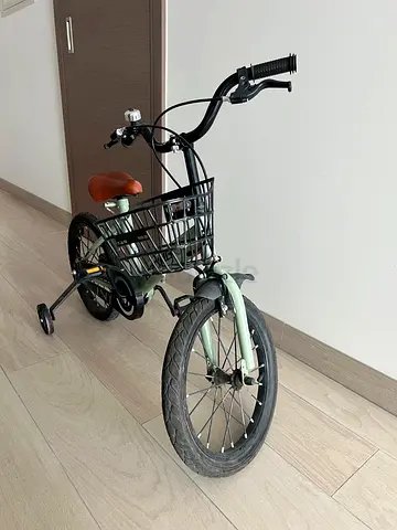 Children's green 16 inch bicycle with basket and training support wheels