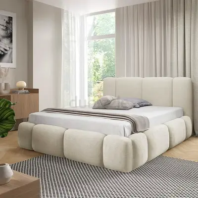 Modern upholstered platform bed with padded headboard and rounded base - cream