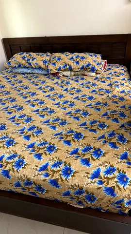 king size wooden bed with mattress and floral bedding