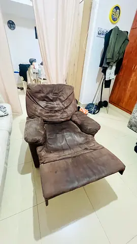 Used brown reclining lounge armchair with footrest — comfortable single seat