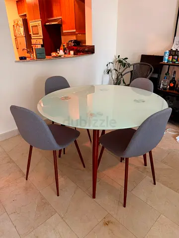 Modern round glass dining table with 4 upholstered chairs