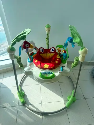Baby jumper/exersaucer with toys - used