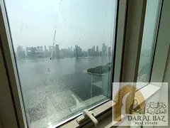 Two bedrooms, living room, and laundry room in Sharjah, annual rent, full sea view, free air conditi
