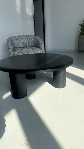 Low round black coffee table with chunky cylindrical legs 100 diameter