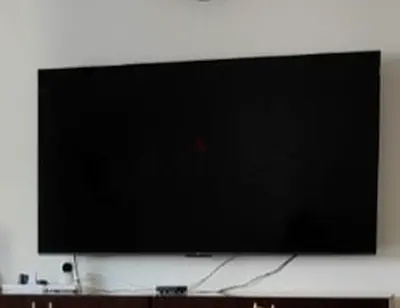 TCL 65" QLED TV wall-mounted - excellent condition