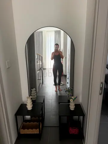 Large mirror with led light and 2 black side tables.