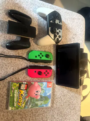 Nintendo Switch console with Joy-Con controllers,Pro-style controller and Kirby and super smash bros