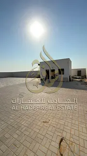 A 10,000-square-foot enclosed yard in Sajaa Industrial Area, fully paved with interlocking stones; i
