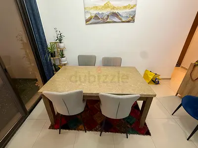 Solid wood dining table with 4 upholstered chairs - good condition