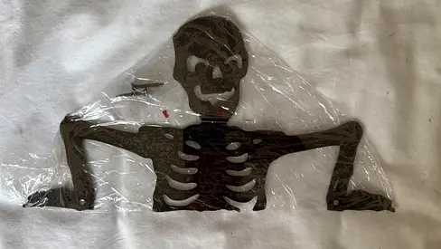 Brand new black metal skeleton garden wall decor (still wrapped)