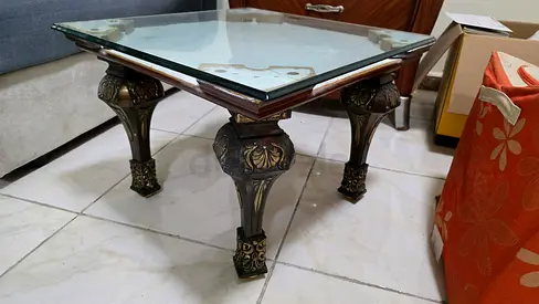 Antique-style square glass top coffee table with carved legs