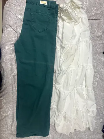 Two women lowers- green denim pants and white skirt