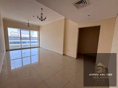 Two bedrooms (including a master suite) and a spacious living area. Features include free central air conditioning, a balcony with a sea view, a large