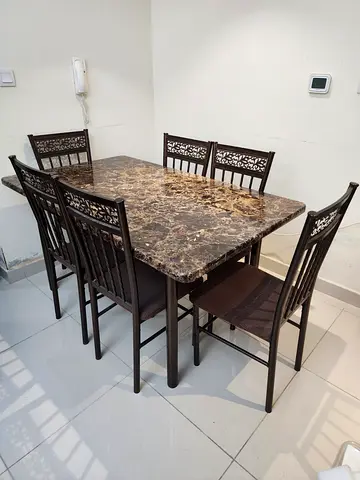 6-seater dining table set with marble top and metal chairs