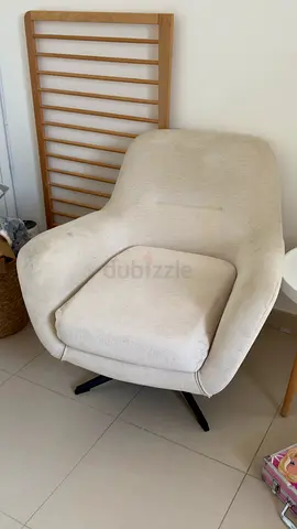 Comfortable Beige Lounge Armchair with Swivel Base. Needs deep cleaning and its perfect.