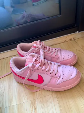 Pink Nike-style low top sneakers, gently used, size unspecified
