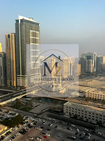 For annual rent in Al Qasba, Sharjah: a spacious two-bedroom apartment with a sea view overlooking