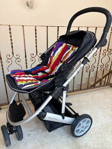 Single stroller in fair condition - colorful seat liner included. Holding Bar missing