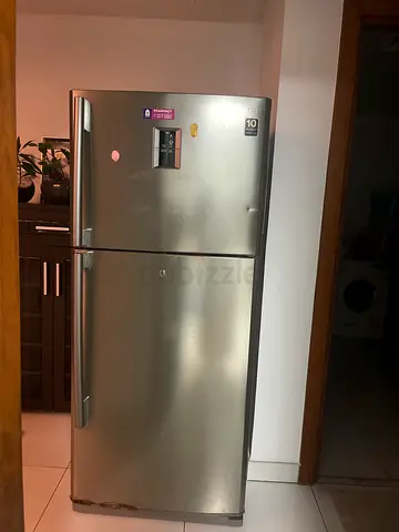 Silver double-door Samsung refrigerator, good working condition