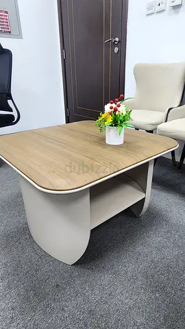 Modern rectangular wooden coffee table with curved base